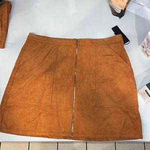 Burnt orange high waisted mini skirt. NWT never worn. Size Large and XLarge